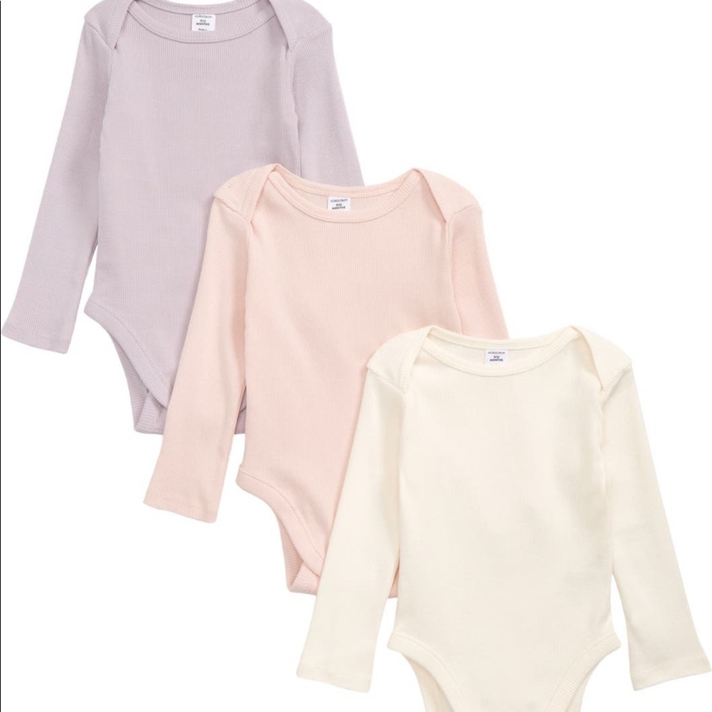 Set of three baby girl organic bodysuits. Never worn with tags attached.